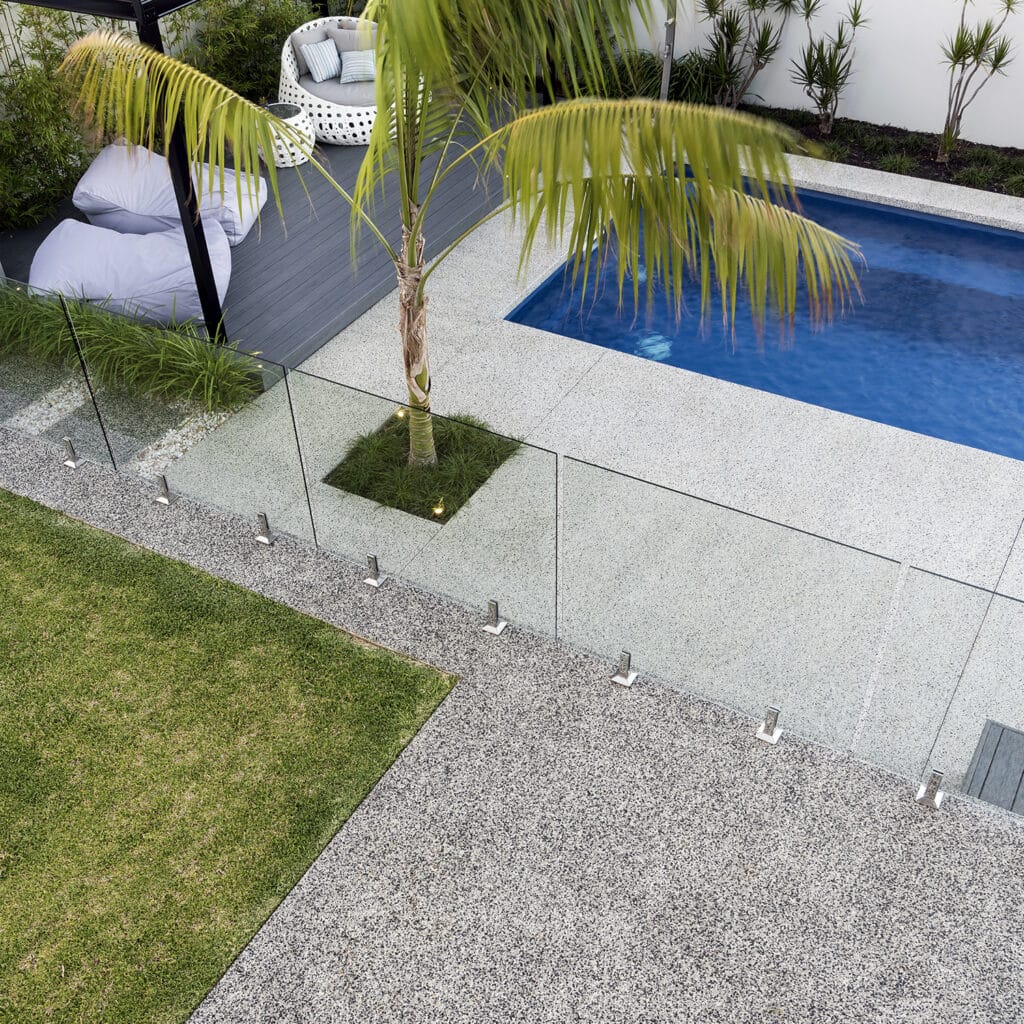 Overhead shot of exposed aggregate path leading to alfresco area and pool