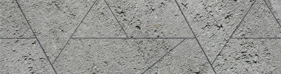 Swatch of scored geometric liquid limestone in charcoal colour