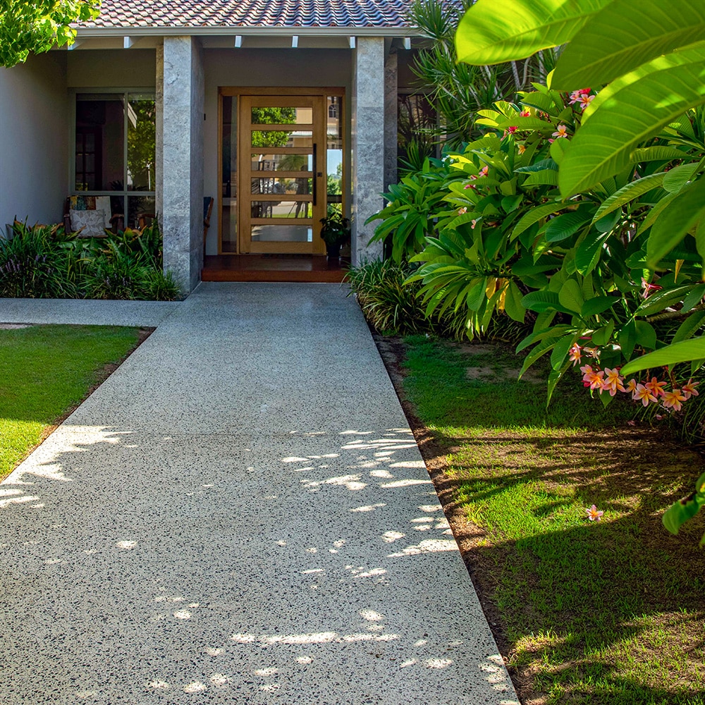 Honed Concrete Pathway alongside a tropical garden in front of a Perth home