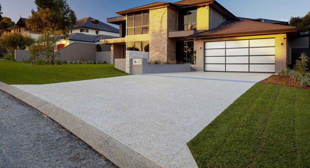 Honed concrete driveway in front of a residential home